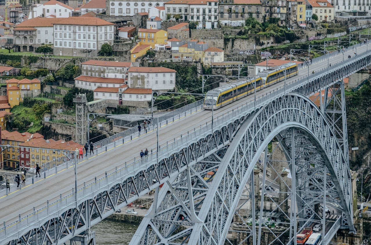 Tram crossing the iconic Dom Luís I Bridge in Porto, Portugal.