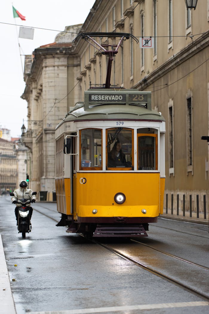 A classic yellow tram travels through Lisbon's historic streets, capturing its charm and essence.
